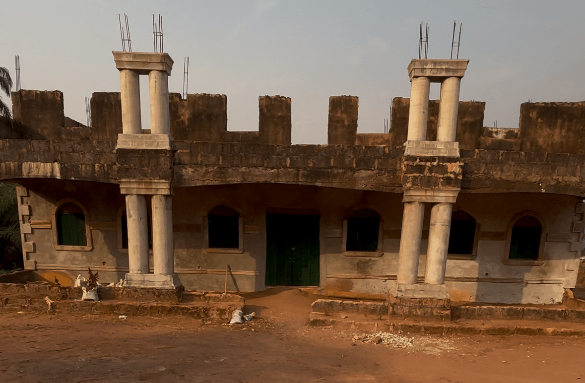 Front view of the unfinished church façade with columns and exposed upper walls